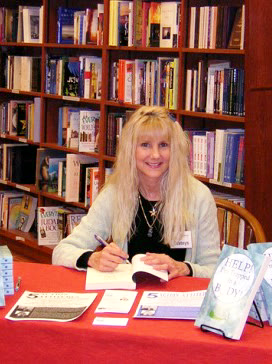 Esateys signing copies of her book at a bookstore event