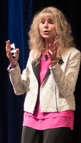 Esateys, mid-gesture, speaking on stage