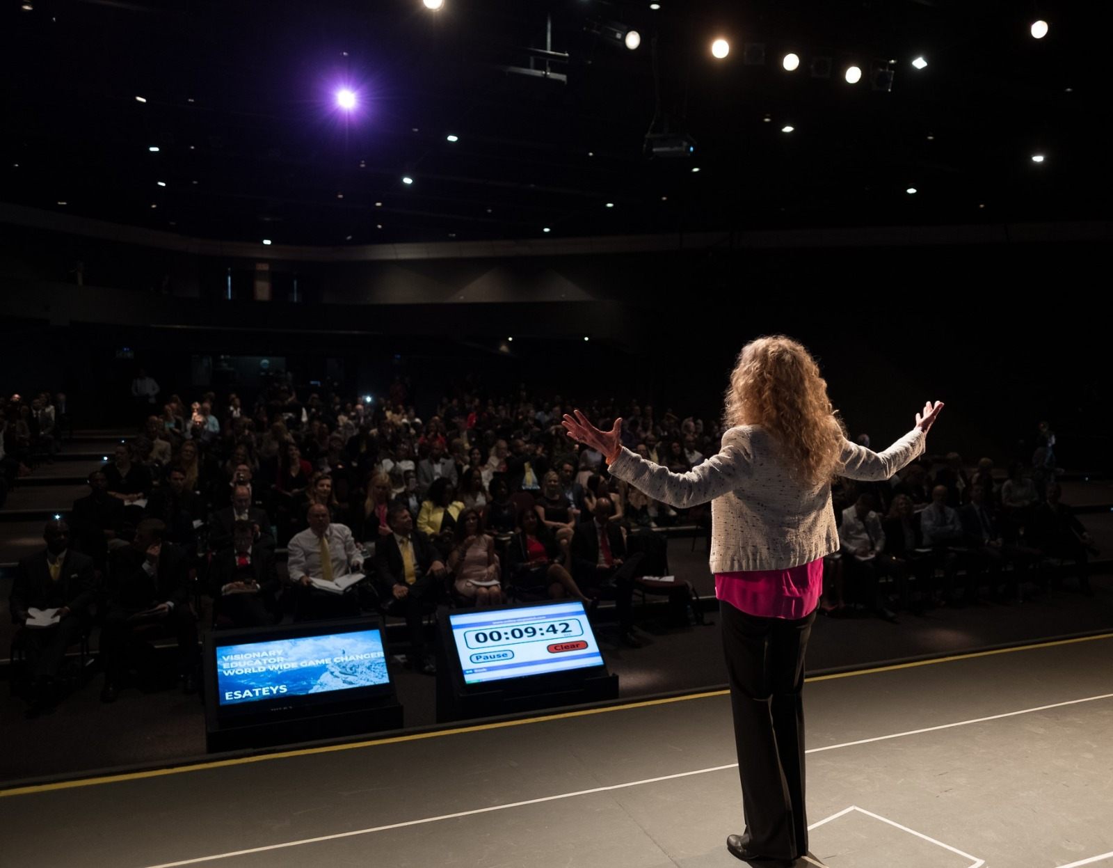 Esateys addressing a full auditorium as an international speaker